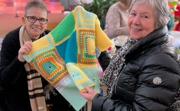 Some of the volunteer with completed knitted and crocheted squares.